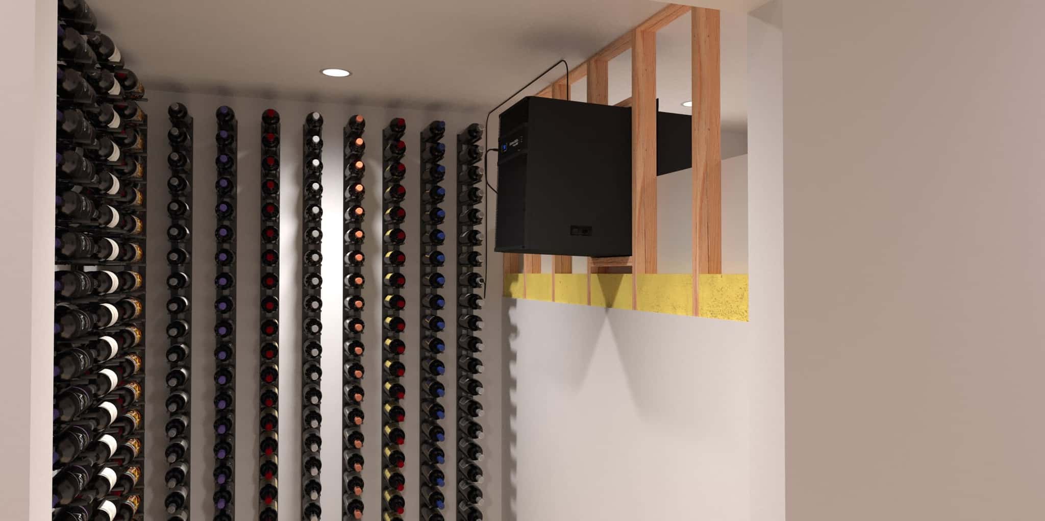 Wine bottles are stored horizontally on wall-mounted racks in a climate-controlled room with unfinished wooden framing and a WhisperKOOL Extreme 8000ti cooling unit.