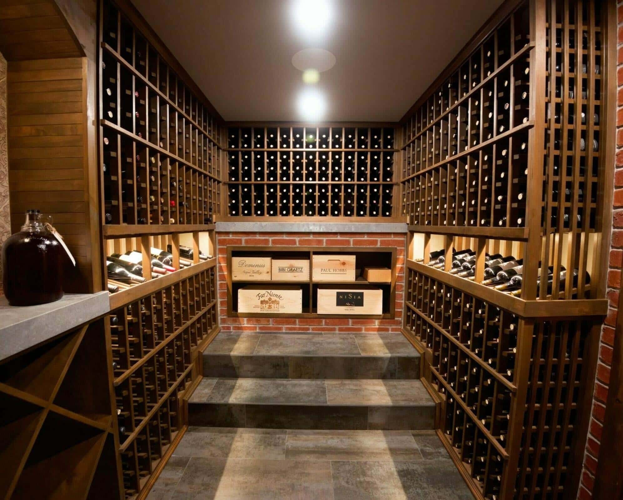 Wine cellar with mixed round and angled racks against a stone wall