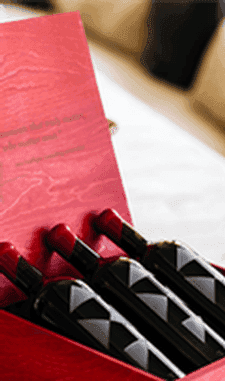 AXR Flagship wine bottles nestled in an open red presentation gift box