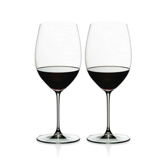 Two Riedel Veritas Cabernet Merlot wine glasses filled with red wine