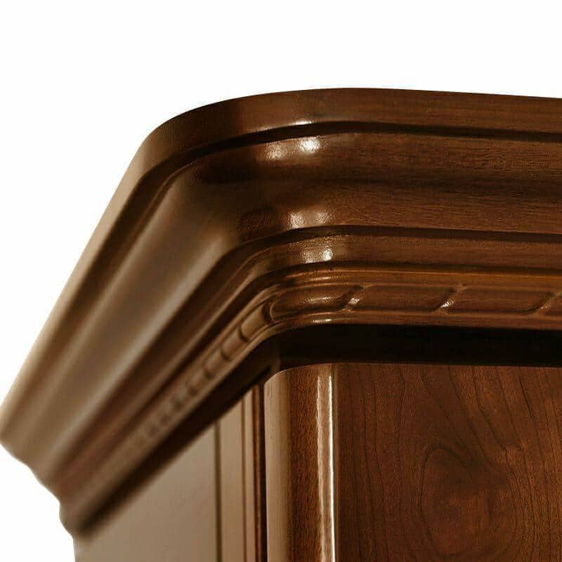 Close-up crown molding detail of a Le Cache provincial wine cabinet on white background