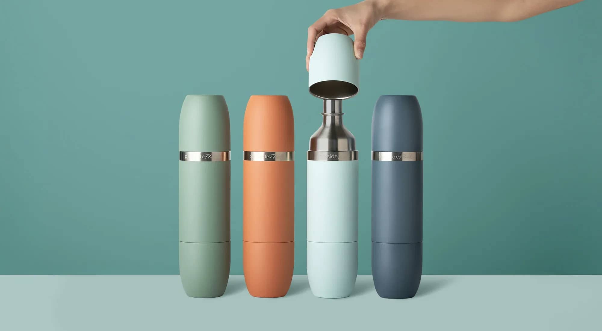 Hand lifting a magnetic tumbler off an assembled Parkside Flask shaker