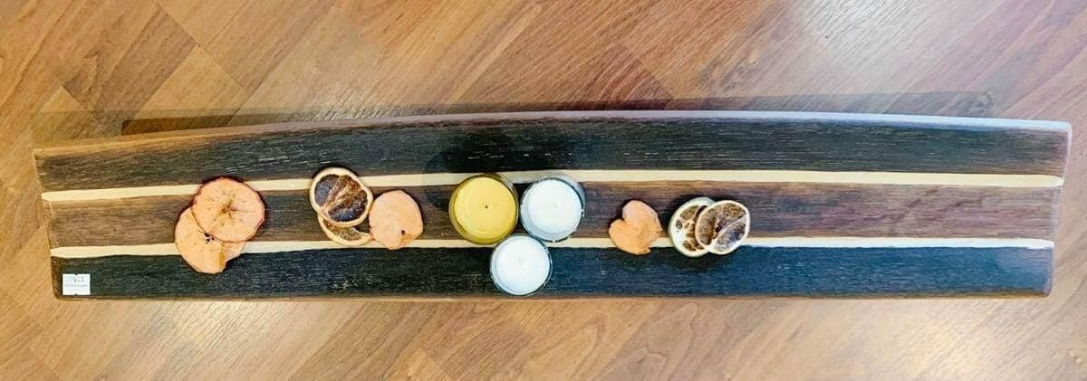 Wine stave charcuterie board with dried fruit and cheese garnish