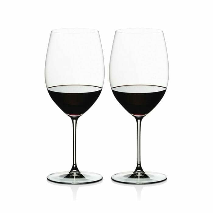 Two Riedel Veritas Cabernet Merlot wine glasses filled with red wine