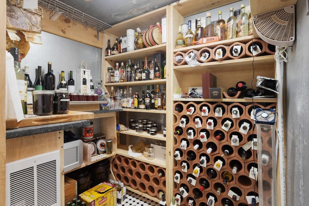 Cluttered home wine storage room with terracotta bottle racks