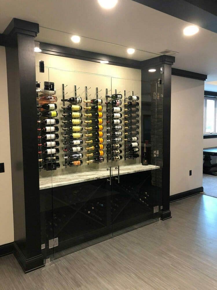Glass-front wine cellar cabinet with mirrored back and stemware