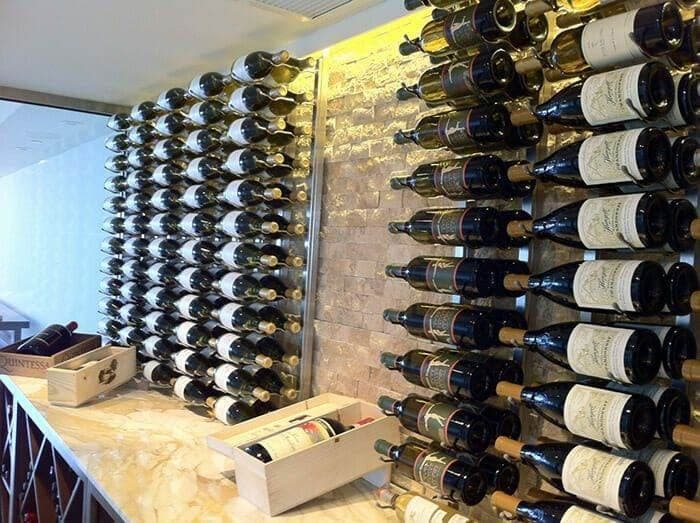 Wine cellar with white and red bottles racked on a stone accent wall