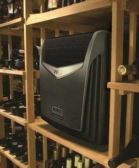 Wall-mounted wine cellar cooling unit installed among wood wine racks