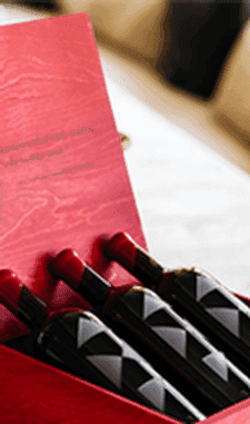 AXR Flagship wine bottles nestled in an open red presentation gift box