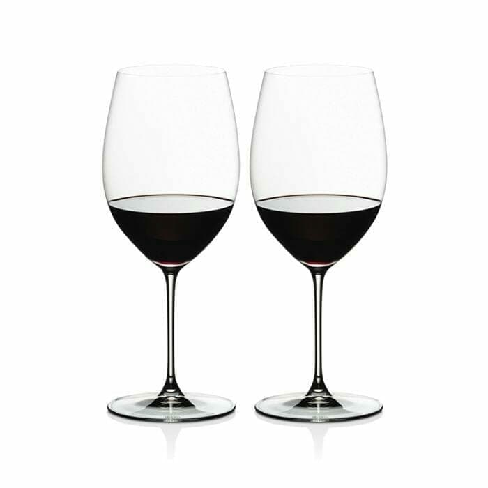 Two Riedel Veritas Cabernet Merlot wine glasses filled with red wine