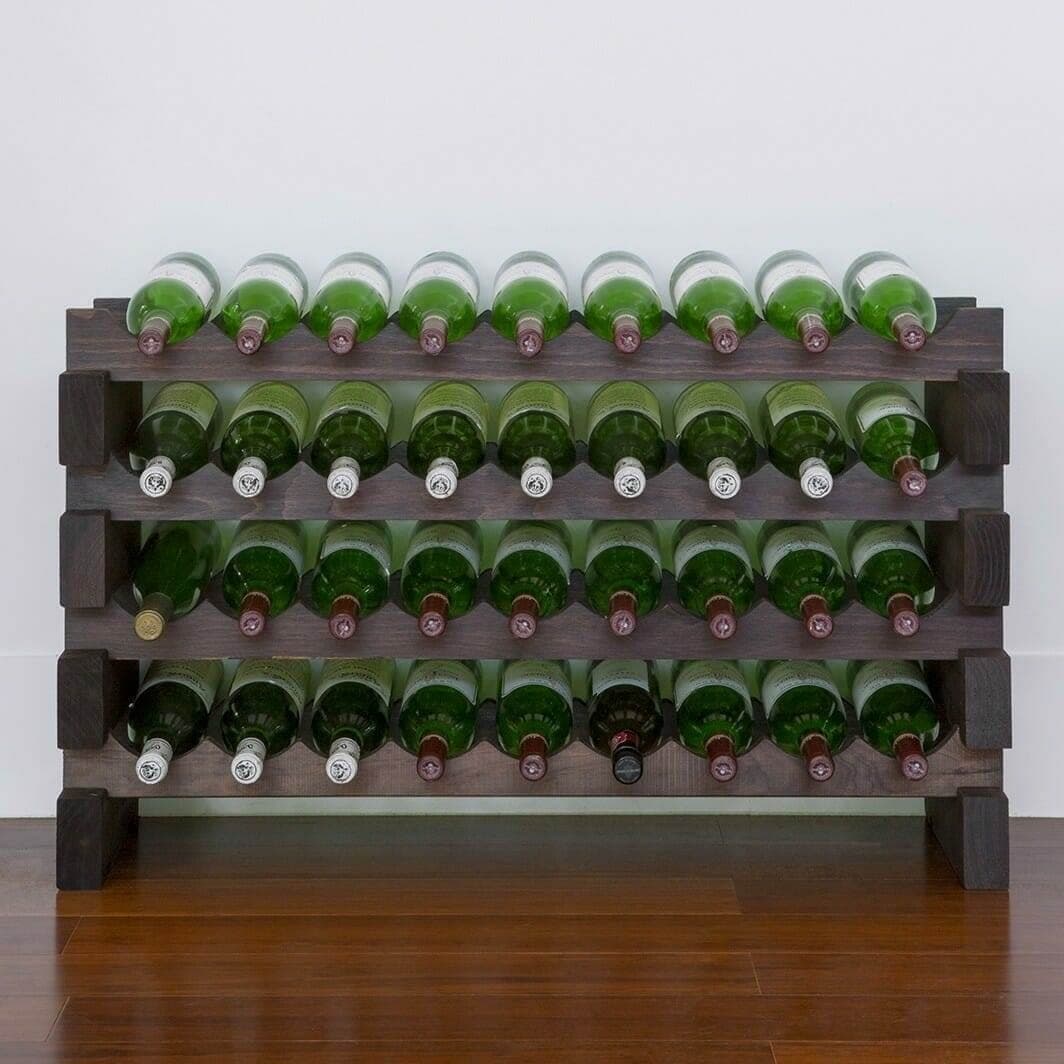Stained modular wine rack holding green wine bottles