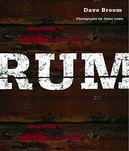 Rum book cover with bold white lettering on stained wood planks