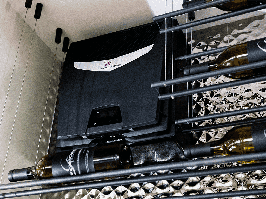 A Wine Guardian cooling unit installed above a mirrored wine rack
