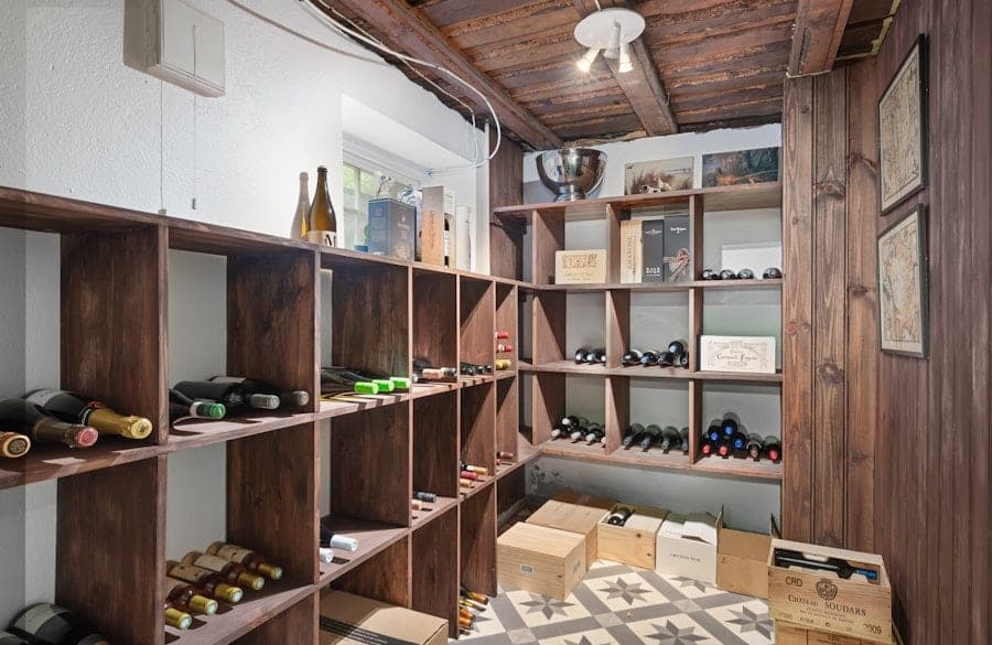 Rustic wood-shelved cellar with cardboard wine crates and a quilt