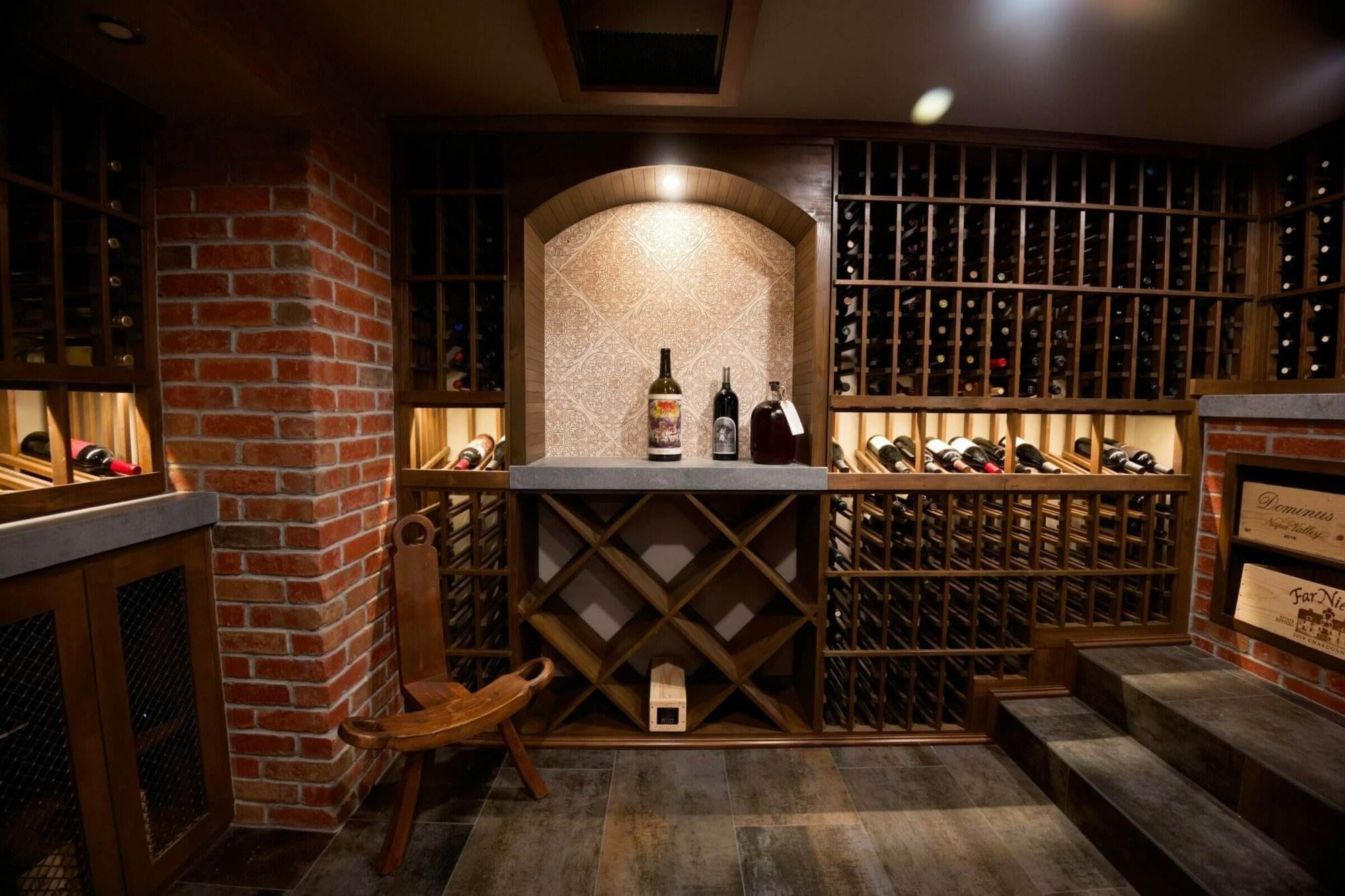 Brick arches and wooden wine racks surround a bottle display alcove.