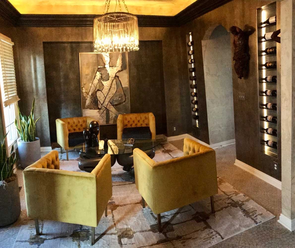 Wood wine bottle shelves lit under a restaurant bar counter