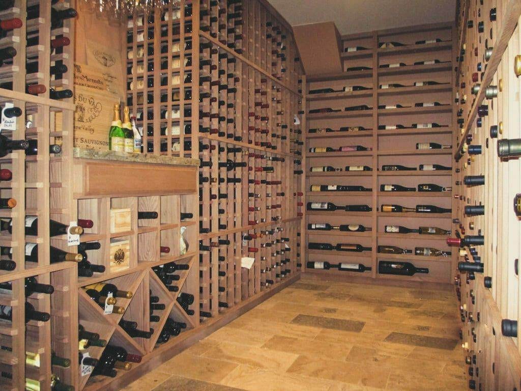 Residential wine cellar with a tasting counter and stone tile floor