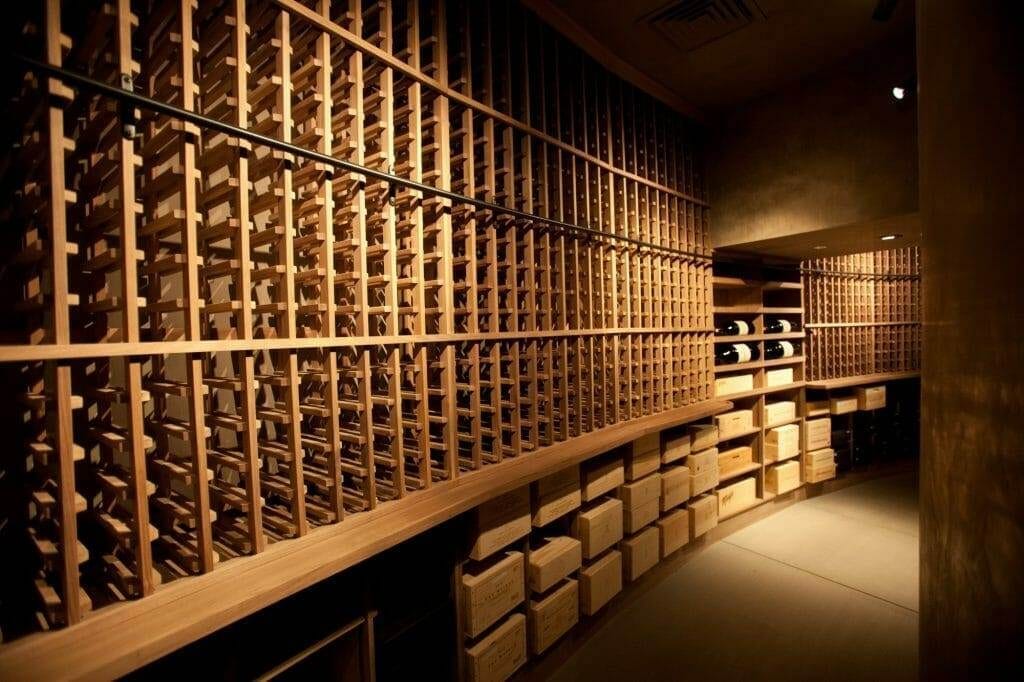 Wine cellar with wooden lattice racks and stacked wood storage crates below