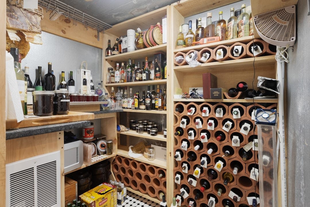 Cluttered home wine storage room with terracotta bottle racks