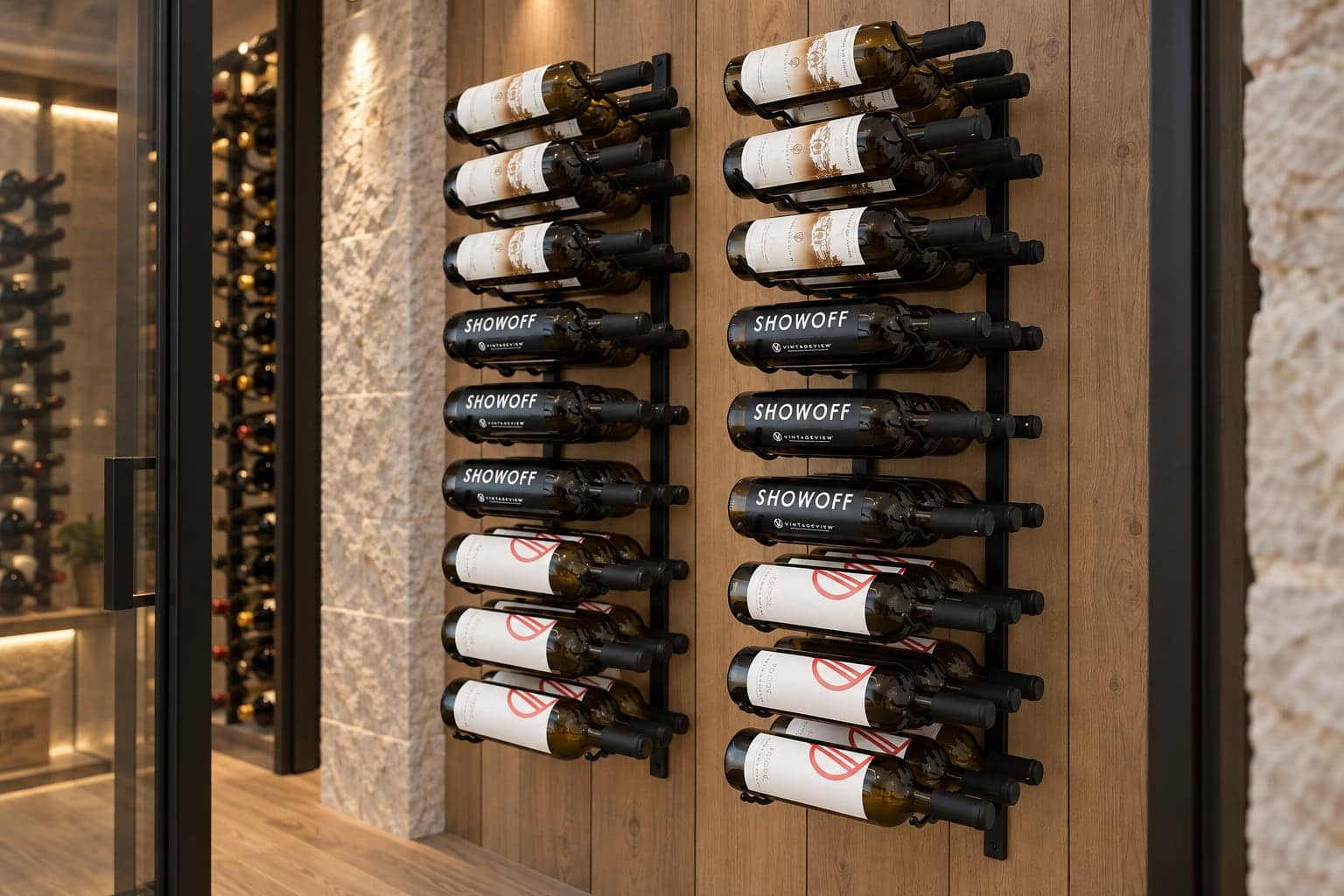 Two label-forward black wine racks mounted on a wood wall beside a glass cellar.