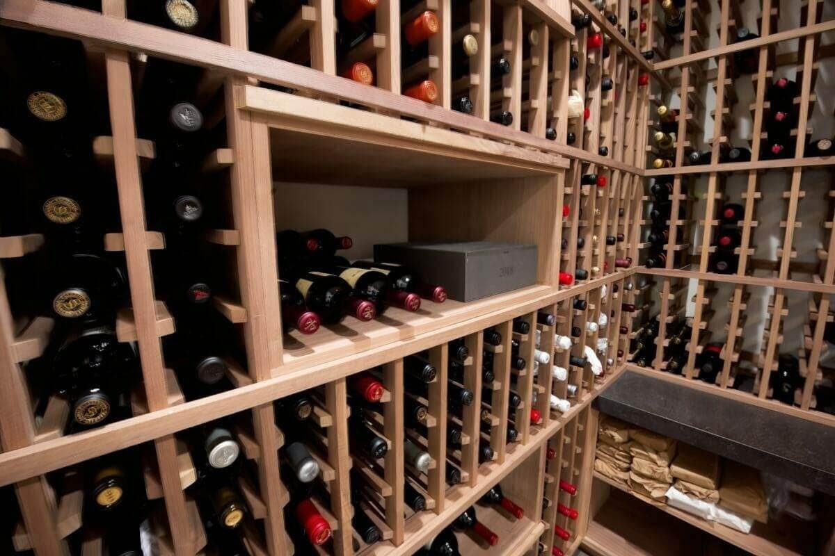 Wooden racks turn a corner above case-storage cubbies and a dark counter.