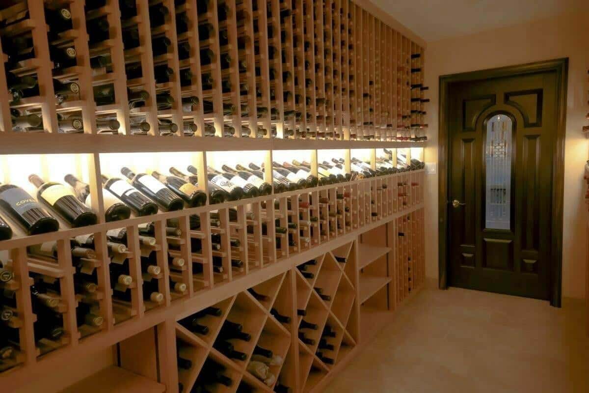 Wooden bottle racks combine individual slots, an illuminated display row and diamond bins.