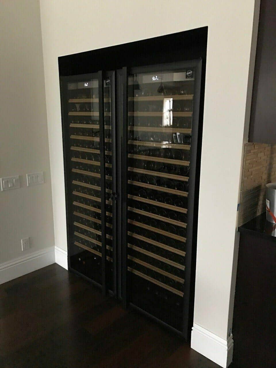 Twin Transtherm wine cabinets built into a hallway niche with dark wood floors