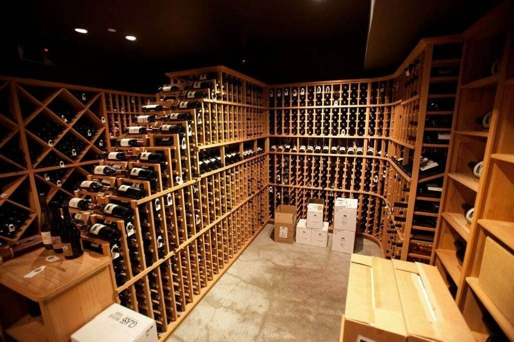 Installed wine cellar with diagonal bins and shipping boxes on the floor