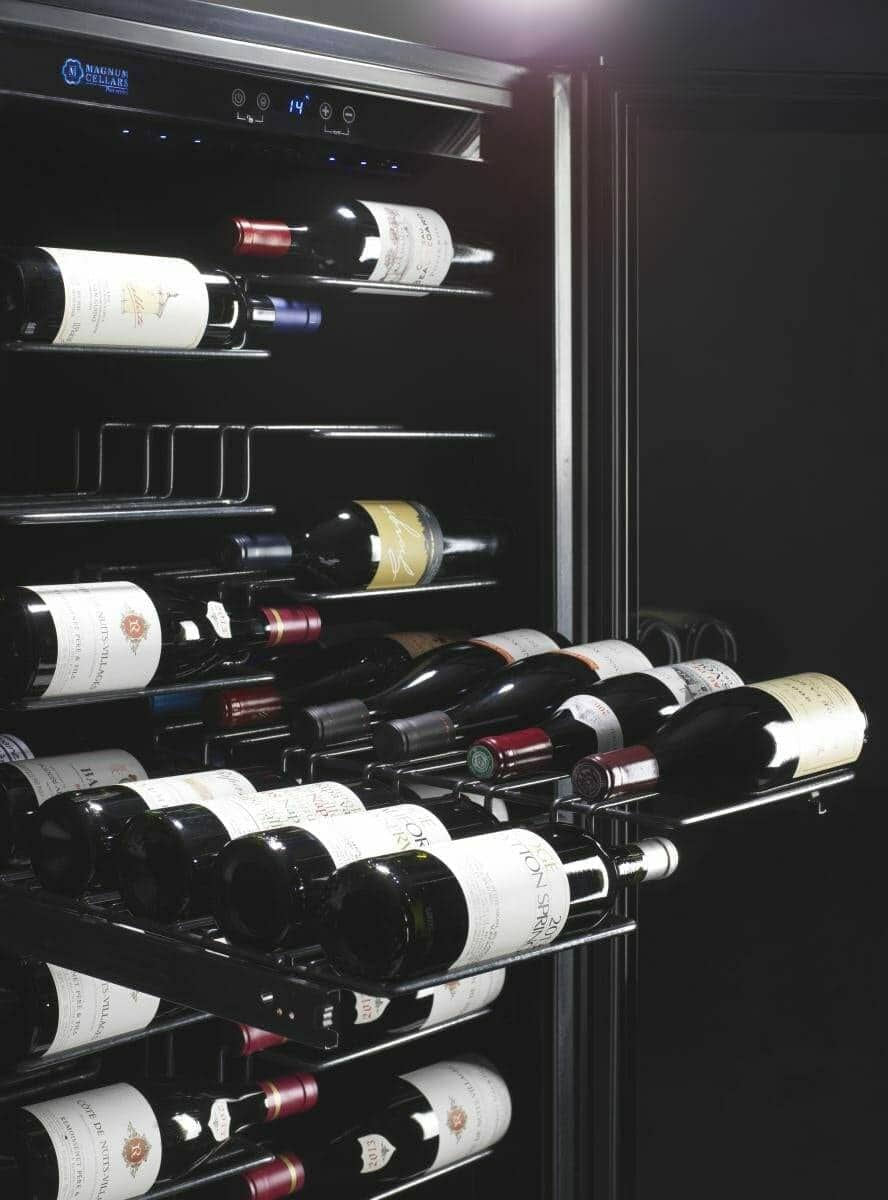 Close-up of wine bottles racked inside a black glass-door wine cabinet