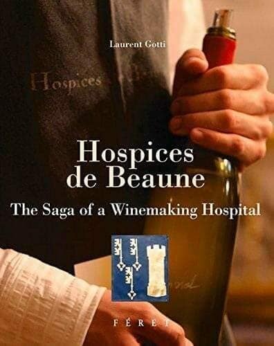 Hospices de Beaune book cover showing a hand holding a wine bottle