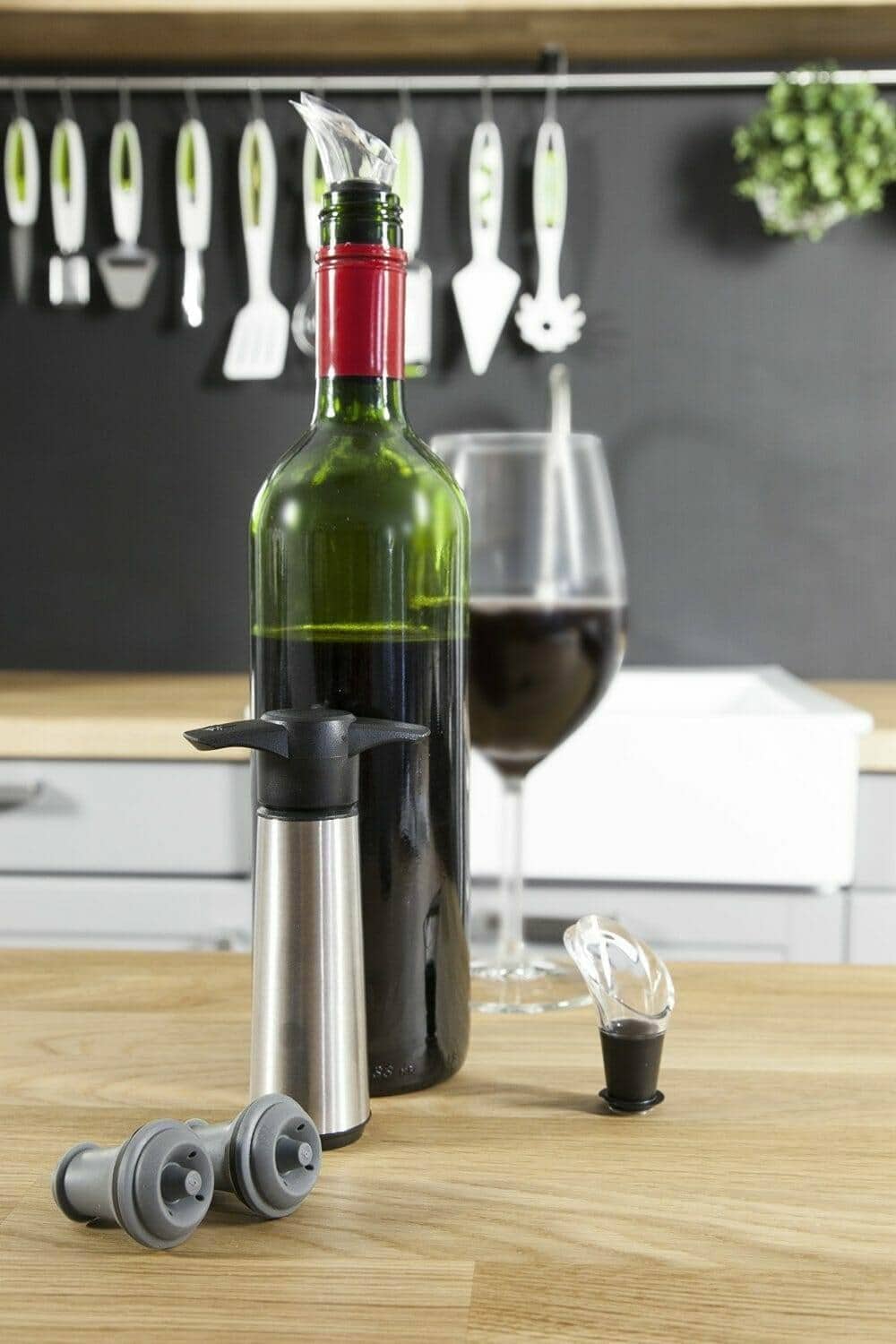 Vacuvin wine saver pump and stoppers staged on a kitchen counter
