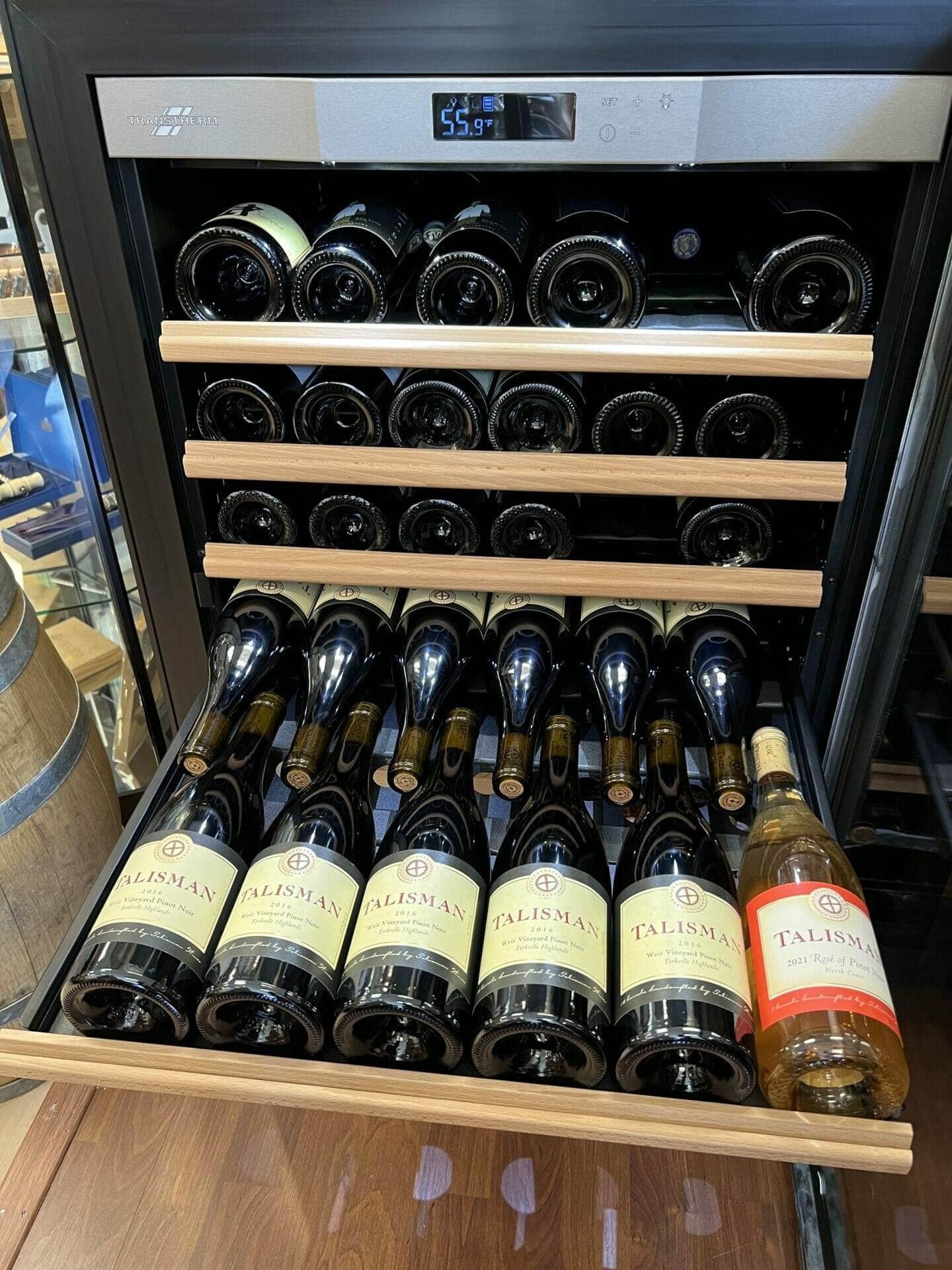 Transtherm wine cabinet drawer pulled out showing rows of Talisman white wine bottles