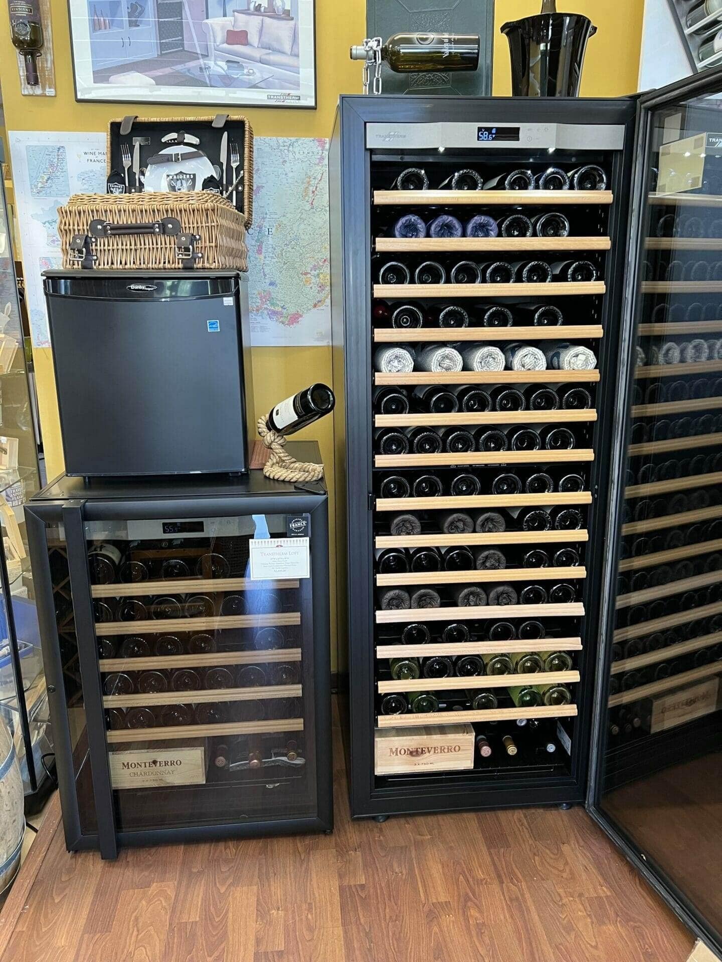 Showroom pairing of a small wine fridge and tall Transtherm cabinet beside wicker basket