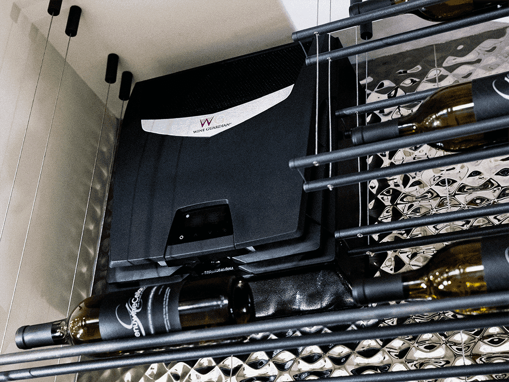A Wine Guardian cooling unit installed above a mirrored wine rack