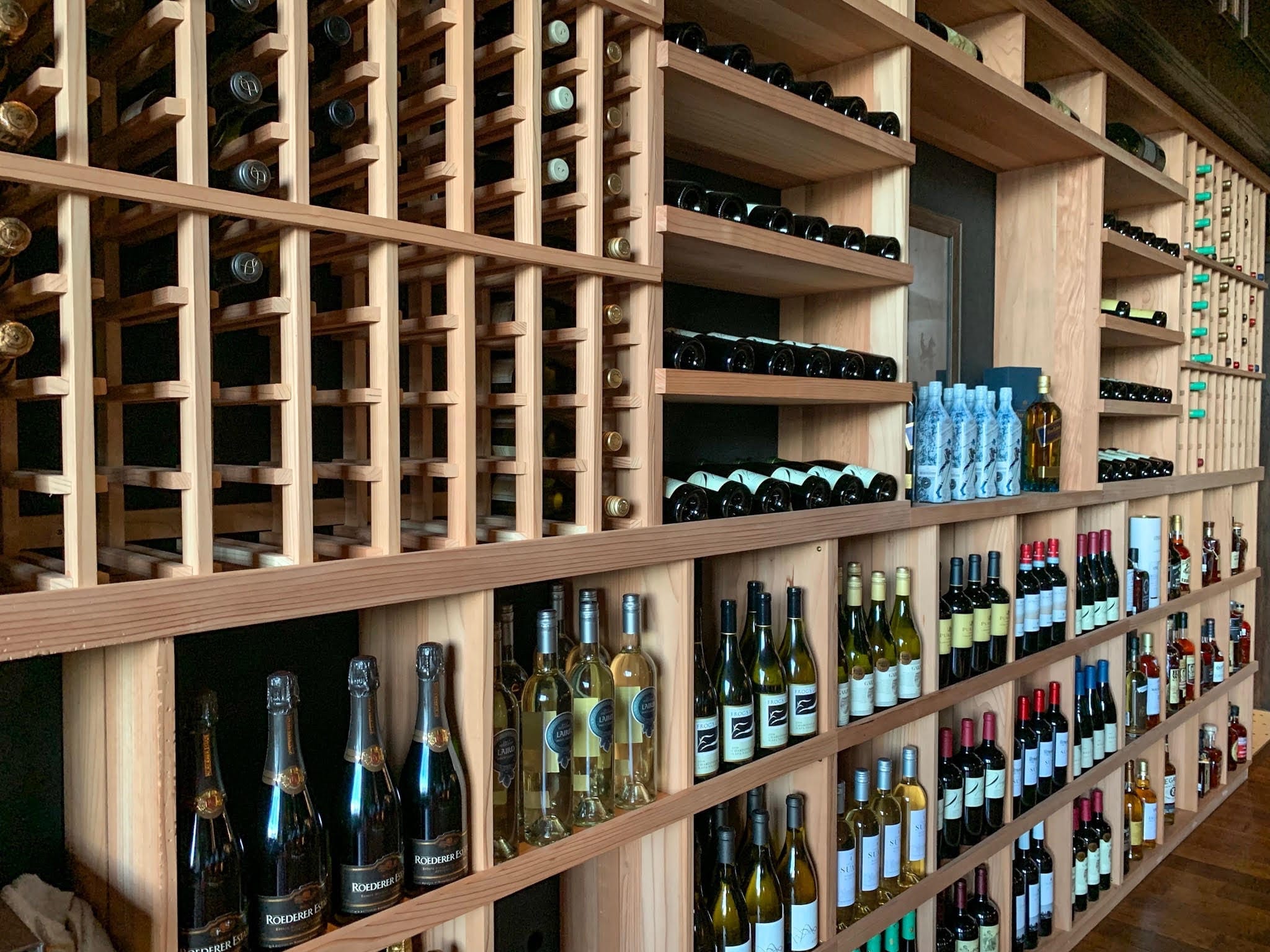 Bounty Hunter restaurant dining room with a lit glass wine cabinet