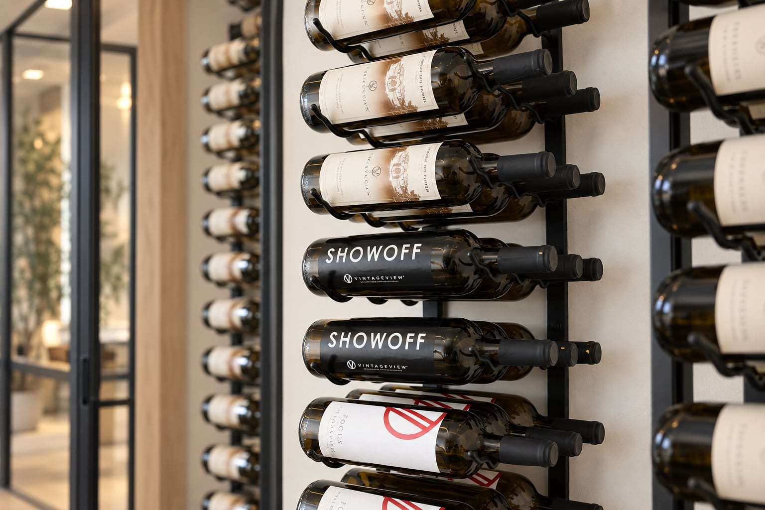 Close view of bottles arranged horizontally on a black metal wine rack