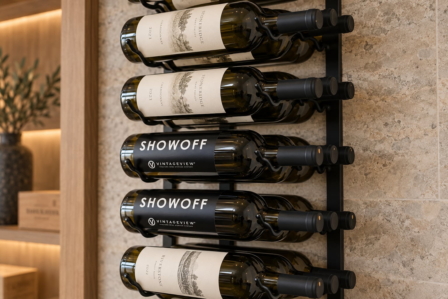 Close-up of labeled Stoneridge and Showoff wine bottles in a black VintageView wall rack