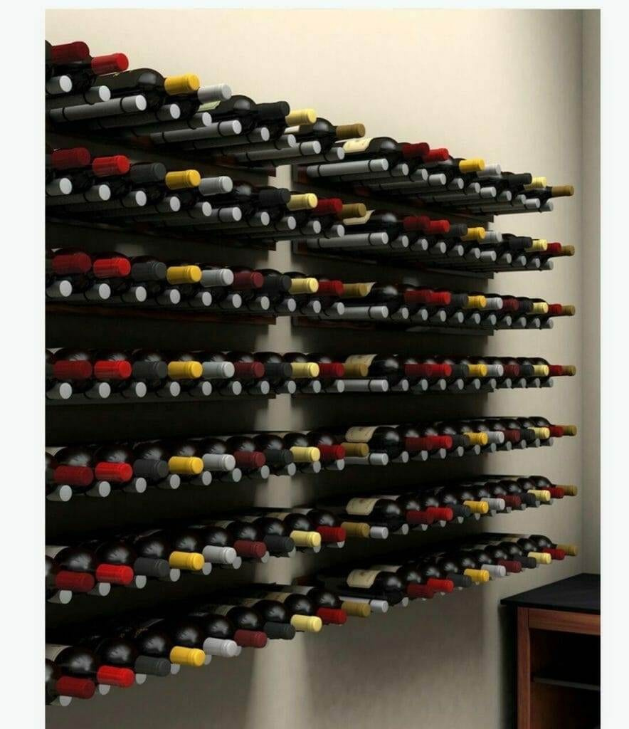 Label-forward black metal wine racks holding bottles along a white wall
